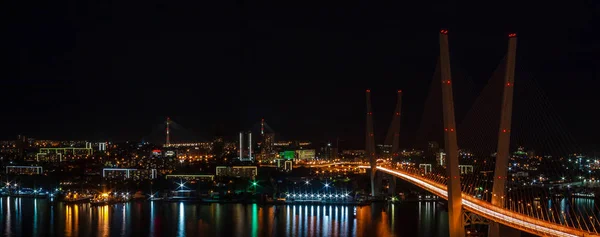 Golden Bridge across the Golden Horn Bay. Panorama of night Vladivostok.