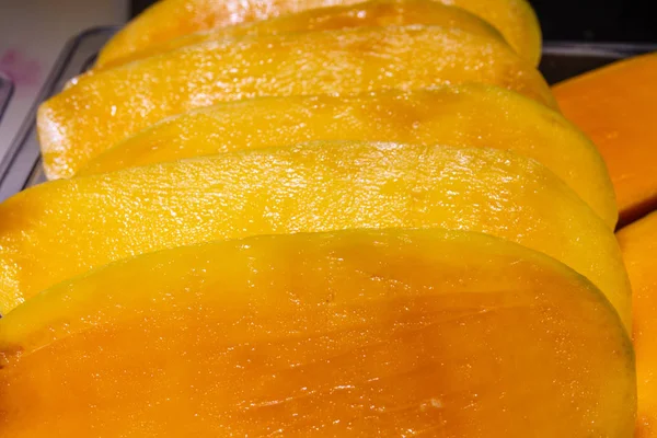 Fresh cut mango fruits on the counter of the Asian market in China