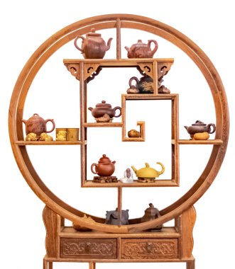 Wooden shelf and ceramic teapots, cups, and other attributes for a traditional tea ceremony. Isolated on white background.