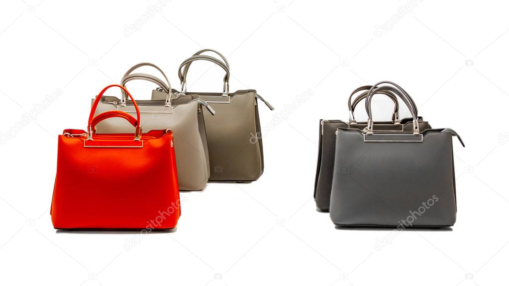 A set of stylish and modern women's handbags from fresh and relevant models of red and beige colors with black and gray elements. Isolated on white background
