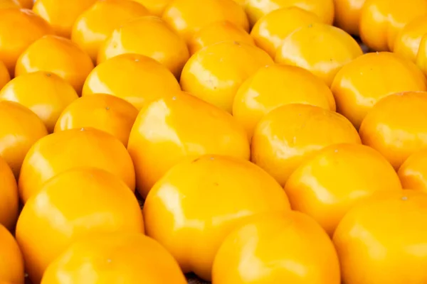Solid background of fresh ripe and natural yellow tomatoes — Stock Photo, Image