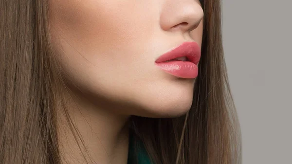 Perfect natural lip makeup. Close up macro photo with beautiful female mouth. Plump full lips. Close-up face detail. Perfect clean skin, light fresh lip make-up. Beautiful spa tender lip