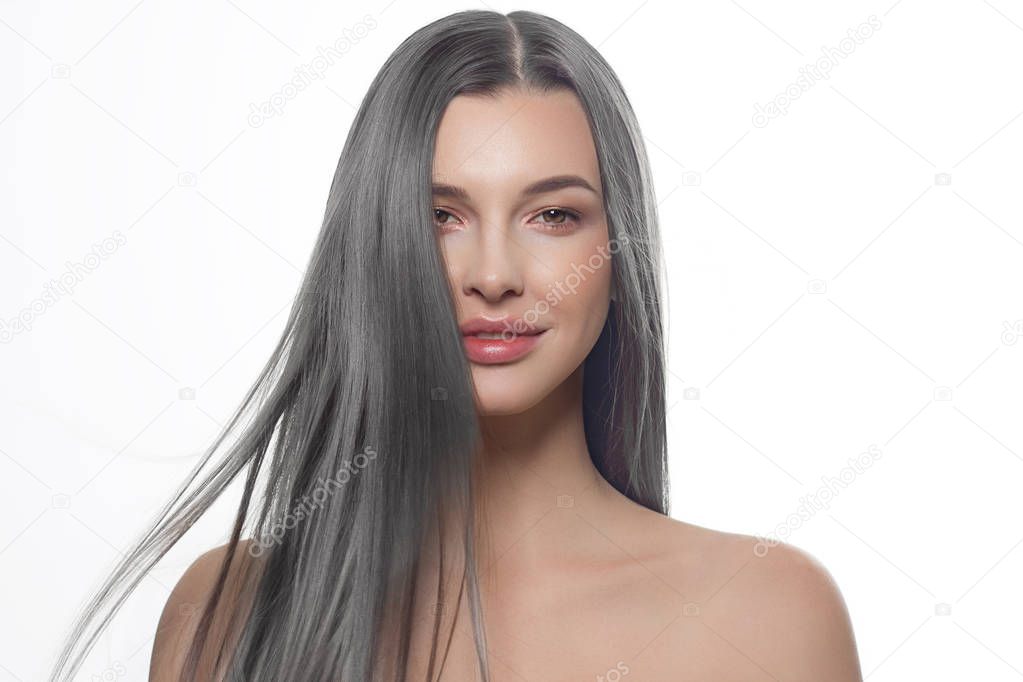 Close-up beauty portrait of a woman with long gray hair and red lipstick. Lamination and hair coloring, day and evening makeup. Anti-aging care, spa and cosmetology