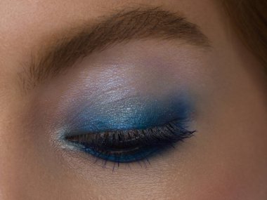 Kapalı kadın gözleri, parlak makyajlı, harika şekilli kaşları, aşırı uzun kirpikleri var. Makyaj kutlaması, lüks göz falı. Güzel gözlü makro. Güzel görüş.