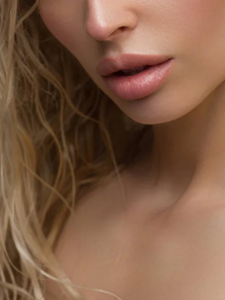Sexual full lips. Natural gloss of lips and woman\'s skin. The mouth is closed. Increase in lips, cosmetology. Natural lips. Great summer mood with open eyes. fashion jewelry. Pink lip gloss