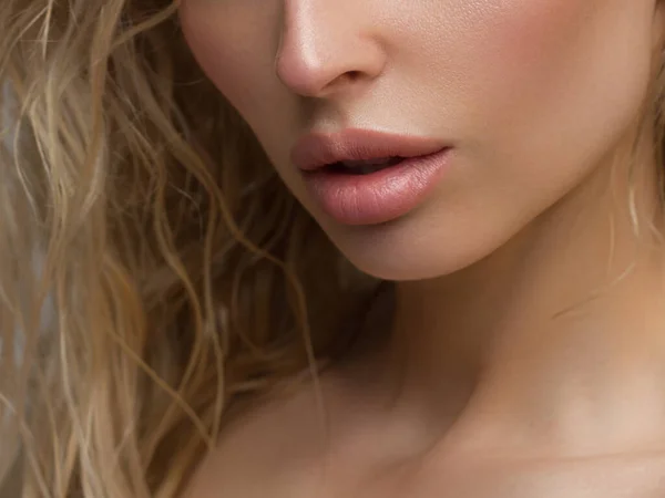 Close-up of woman\'s Lips with Fashion pink Make-up and Manicure on Nails. Beautiful female full lips with perfect Makeup. Part of female face. Macro shot of beautiful make up on full lips