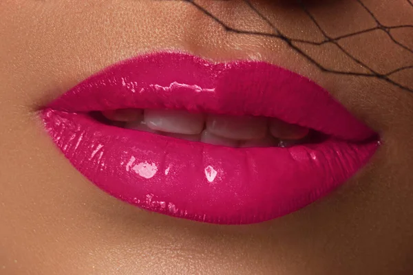 Sexual full lips. Natural gloss of lips and woman\'s skin. The mouth is open. Increase in lips, cosmetology. Natural lips. Great summer mood and evening make up. Pink lip gloss