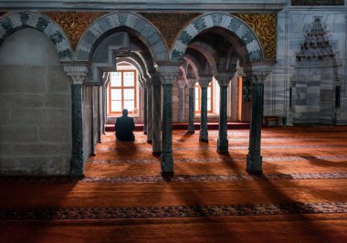 Muslims praying alone in mosque clipart