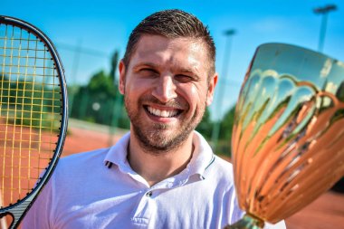 Genç adam güneşli günde tenis oynuyor