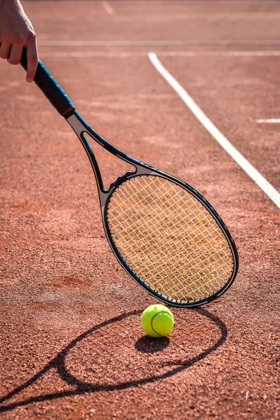 shadow of a tennis player in action on a tennis court