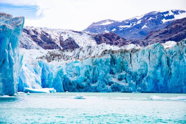 contrasts of ice and earth. Glacier Ohiggins. Patagonia. Region of Aysen. Chile clipart
