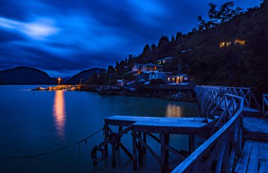 night photography of Caleta Tortel and its houses. Austral road. Region of Aysen. Chile clipart