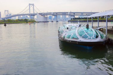 Tokyo, Japan, 04/21/2017, speedboat at the pier. The Island Of Odaiba. Since 2004, a river tram of the third Millennium has been running on the Sumida river, which flows in Tokyo. The ship, named Himiko. He makes regular flights on the Sumida river. clipart