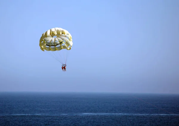 Cabo San Lucas, Mexico, Flight on a parachute behind a boat.  It is a flight on a parachute behind a boat, or as it correctly is called parasailing. Popular beach activities include water skiing, parachuting, banana boating and jet skiing.