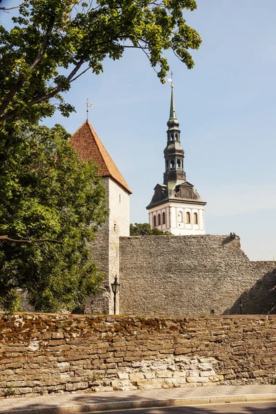 Tallinn, Estonia, Maiden tower and spire of St. Nicholas Church. The medieval Maiden tower (Neitsitorn) is one of the most famous sights of old Tallinn. It is included in the UNESCO world heritage list. Probably, the tower in its original form was bu