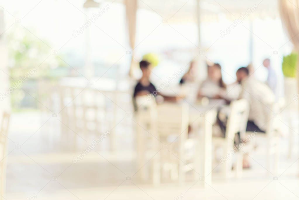 Blurred background of restaurant with people.