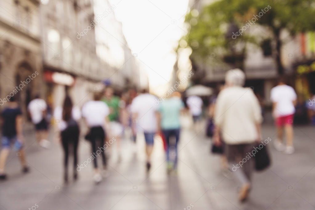abstract blur people background, silhouettes of unrecognizable people walking on a street