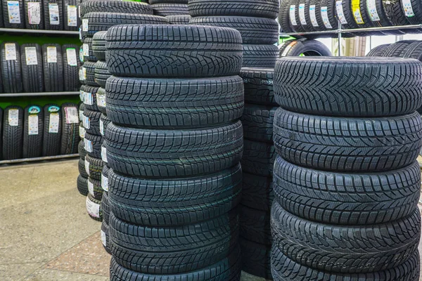 Bastidor con variedad de neumáticos de coche nuevos en la tienda de automóviles — Foto de Stock