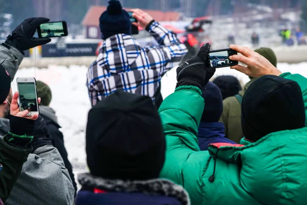 fans are filming sports competitions with mobile phones