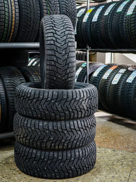 New winter tire set with studs at tire shop — Stock Photo, Image