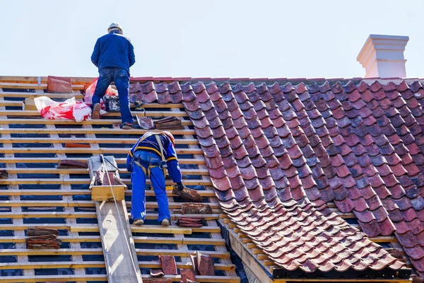 Roof repair of a historic house and replacement of clay tiles Royalty Free Stock Photos
