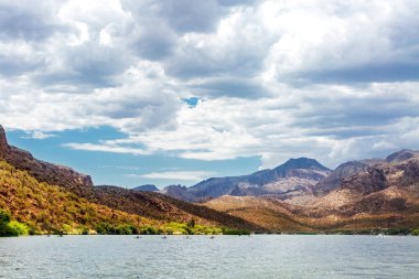 Scenic view of mountain range in the Tonto National Forest and Canyon Lake in Apache Junction, Arizona, USA with people in kayak boats clipart