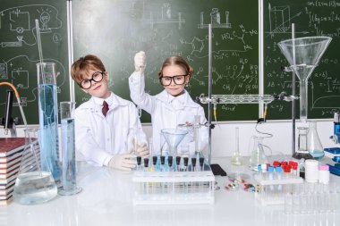 İki çocuk bilim adamları deneyler laboratuvarda yapma. Eğitim kavramı. Erken çocuk gelişimi.