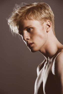 Portre gömleksiz bir gencin stüdyoda poz sarışın saçlı. Erkek güzellik ve sağlık.