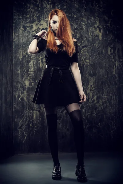 Magnificent woman in black gothic dress over grunge background. Fashion. Gothic style.