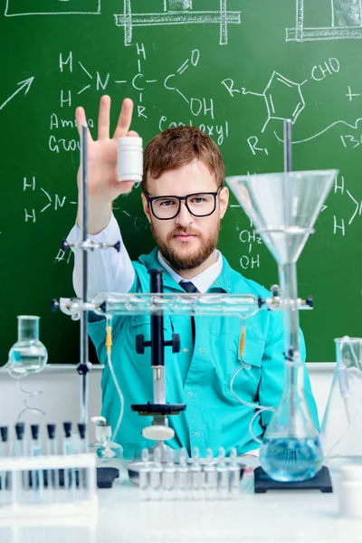 Smartman scientist making chemical experiments in the laboratory. Educational concept.