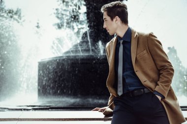 Şık giysileriyle bir şehir Park'ta yürüyordunuz mutlu genç adam. Açık moda. İş tarzı. 