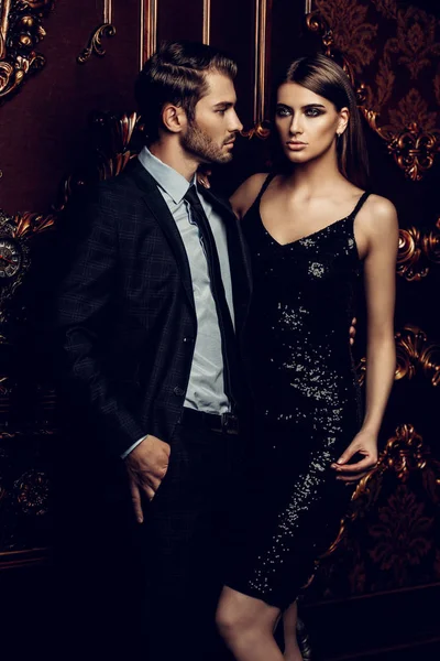 Sexual passionate couple in elegant evening dresses. Luxurious interior. Fashion shot.