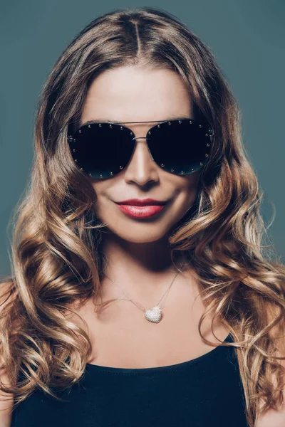 Amazing woman wearing elegant fitting dress and sunglasses. Beauty, fashion concept. Evening dresses collection.