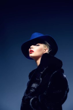 Çok güzel sarışın kadın lüks kürk manto ve şapka poz. Moda, güzellik. Stüdyo vurdu.