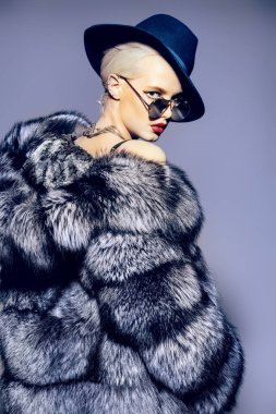 Çok güzel sarışın kadın lüks kürk manto ve şapka poz. Moda, güzellik. Stüdyo vurdu.
