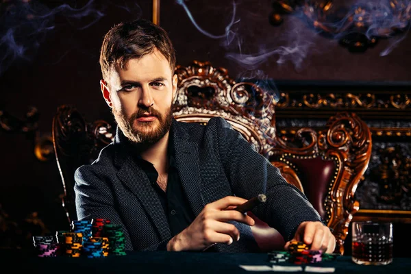 A wealthy mature man playing poker in a casino. Gambling, playing roulette. Rich and luxury.