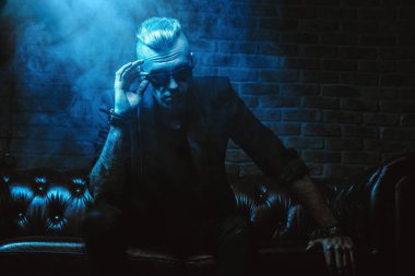 Bir vampir adam gözlüklü karanlık bir odada oturuyor. Klasik tarzı. Güzellik, moda.