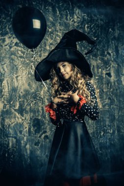 Bir cadı grunge arka plan üzerinde bir kılık kız güzel çocuk. Cadılar Bayramı partisi. 