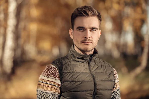 A handsome man in countryside. Autumn fashion for men. Freedom, lifestyle.