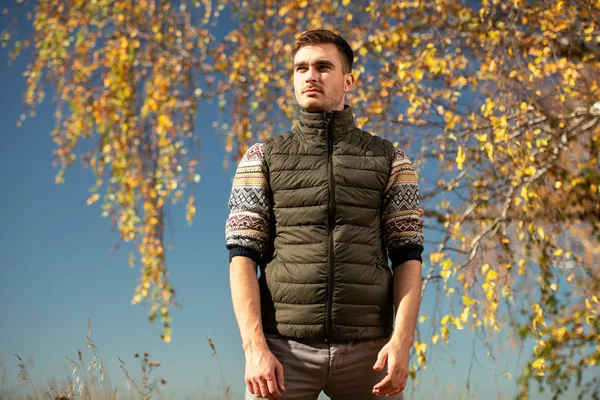 A handsome man in countryside. Autumn fashion for men. Freedom, lifestyle.