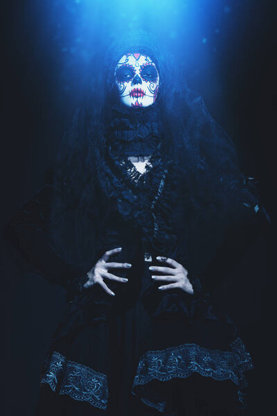 Calavera Catrina in darkness. Sugar skull makeup. Dia de los muertos. Day of The Dead. Halloween.