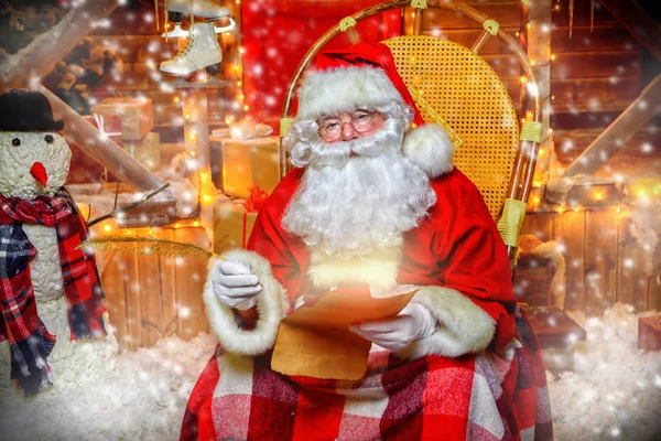 Santa Claus is preparing for Christmas. He writes letters. House of Santa Claus. Christmas decoration.