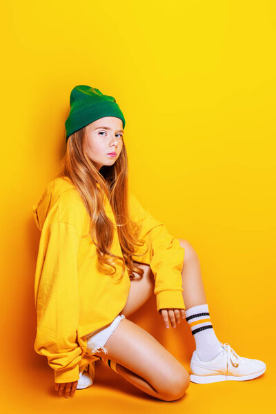 A full length shot of a bright emotional girl. Fashion for active kids.