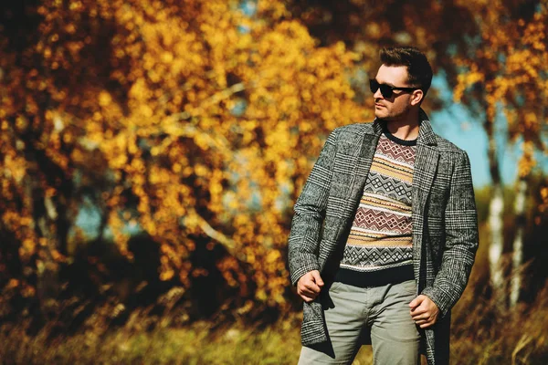 A handsome man in countryside. Autumn fashion for men. Freedom, lifestyle.