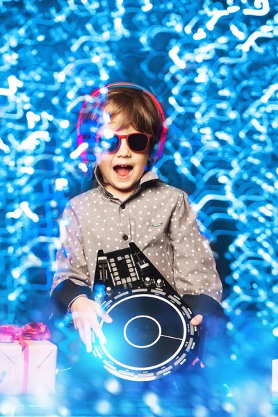 A young dj playing music in sunglasses. Merry Christmas and Happy New Year.