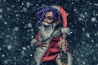 Portrait of a cool punk Santa Claus with bright dreadlocks over black background. clipart