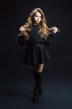 Bir tam uzunlukta portre Studio siyah arka plan üzerinde poz şirin duygusal bir kız. Güzellik, çocuklar ve gençler için moda.