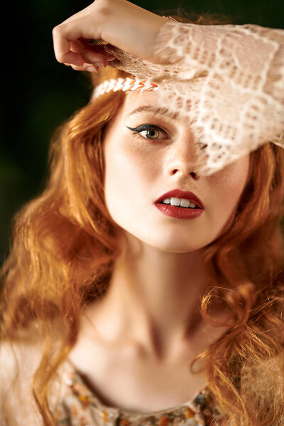 Portrait of a beautiful red-haired girl. Hair coloring. Hippie style. Bohemian style.