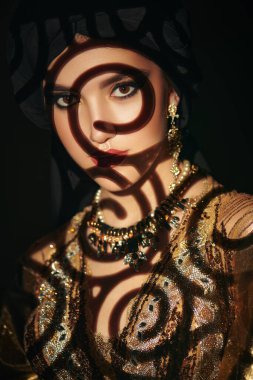 Doğulu peri masalı. Geleneksel makyaj ve siyah tesettüre sahip güzel bir Arap kadının portresi. Makyaj ve kozmetik. 