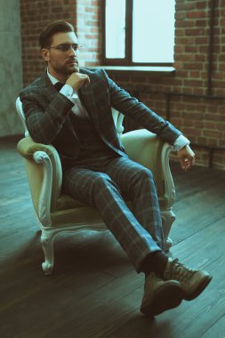 Şık takım elbiseli yakışıklı bir adamın portresi koltukta rahatça oturuyor. Başarılı bir iş adamı. Hayat güzel bir kavram.. 